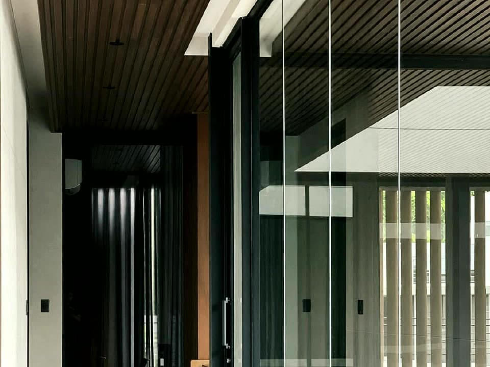 Glass hallway panels with black aluminum framing